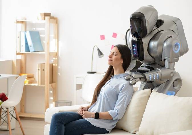 Woman Experiencing Shoulder Massage Therapy By A Robot in a Massage Center.