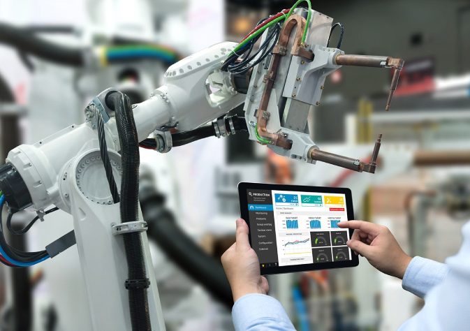 Image of an engineer operate and programming the industrial cobot.