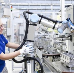 Image of a technical woman lead working with collaborative robot in aircraft sector.