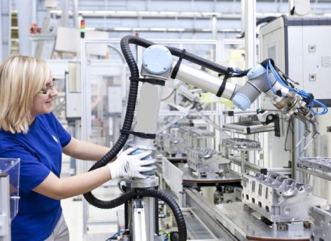 Image of a technical woman lead working with collaborative robot in aircraft sector.