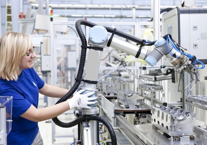 Image of a technical woman lead working with collaborative robot in aircraft sector.