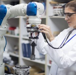 An industrial engineer testing the robot - relationship between robot and human concept.