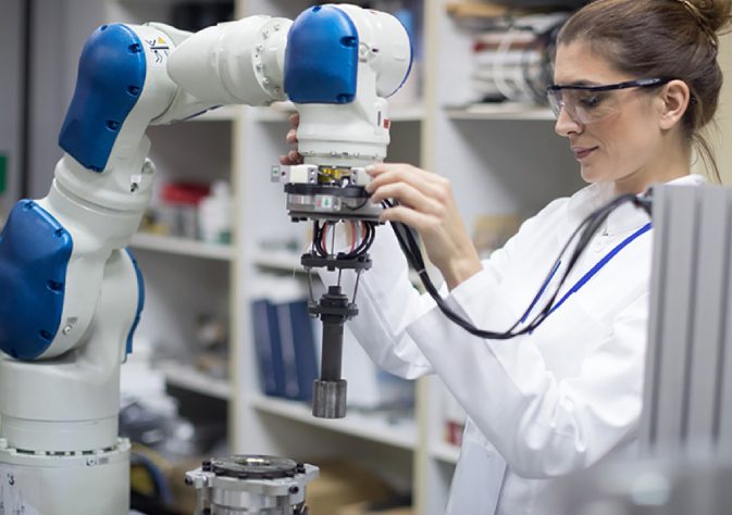 An industrial engineer testing the robot - relationship between robot and human concept.