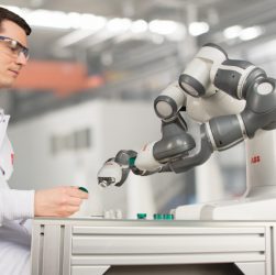 Image showing a manufactring engineer testing the robotic arm.