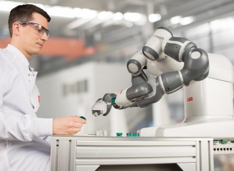 Image showing a manufactring engineer testing the robotic arm.