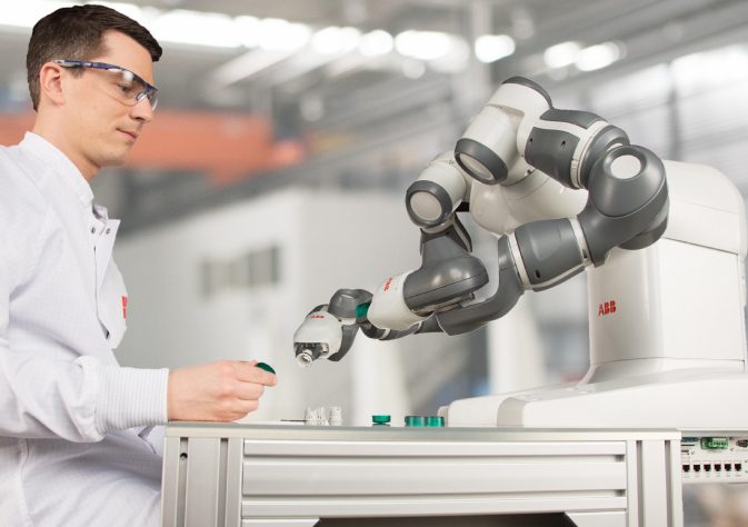 Image showing a manufactring engineer testing the robotic arm.