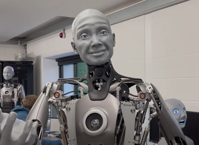 A robot that looks like a man, along with other robots in a room